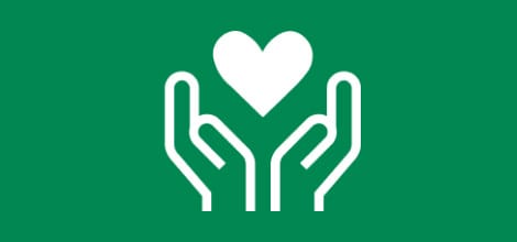 Grünes Icon - Zwei Hände halten ein Herzsymbol