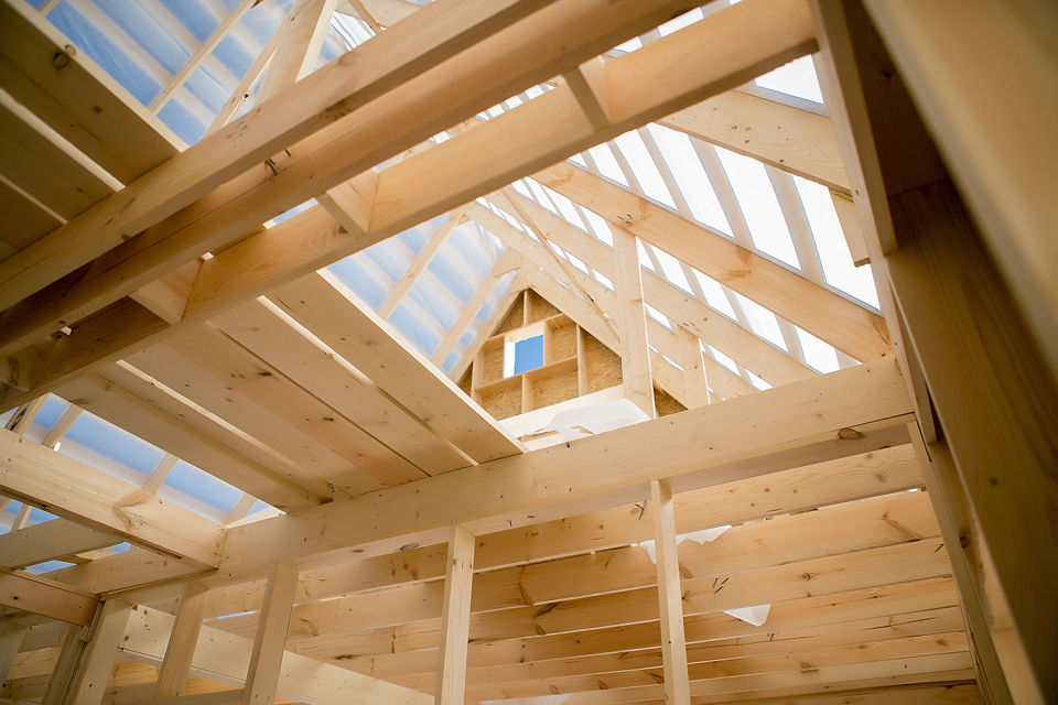 Bauen mit Holz - Blick auf Holzbalken in einem Holzhaus in der Bauphase